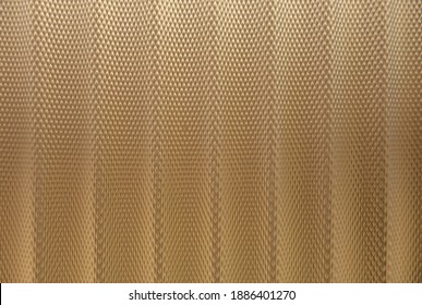 Abstract Background Of Golden Embossed Plastic Surface Close Up