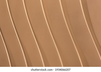 Abstract Background Of Golden Embossed Plastic Surface Close Up