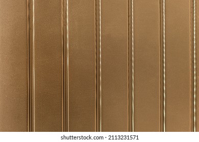 Abstract Background Of Golden Embossed Plastic Surface Close Up