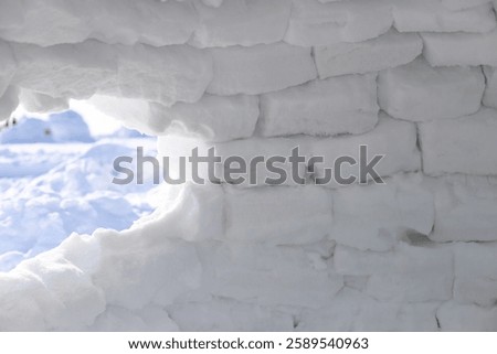 Abstract background. Inside igloo wall with the light shining through the edges of the ice blocks.