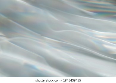Abstract background, interference patterns formed by light. Random, changing pattern.