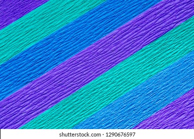 Abstract Background Of Layers Of Colorful Purple, Blue And Green Crepe Paper