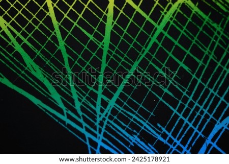 Abstract background of lines, green and blue lines intersecting each other on a black background