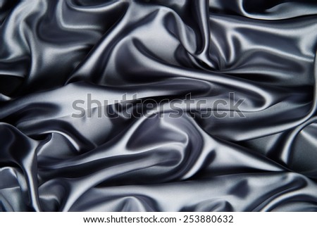 abstract background luxury cloth or liquid wave or wavy folds of grunge metalic silver silk texture satin velvet material or luxurious
