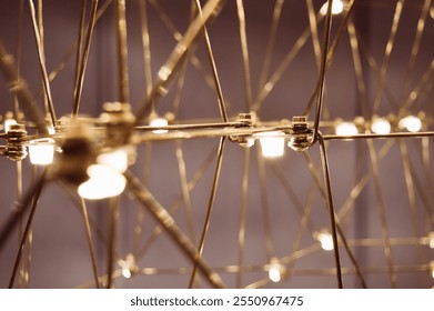 abstract background is a metal structure made of thin rods with light bulbs in a geometric sequence. strange art objects for home and office. High quality photo - Powered by Shutterstock