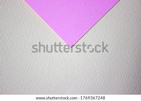Abstract background of minimalism texture of colored paper. Pink triangle on a yellow background. Minimal geometric shapes and lines in pastel colors.