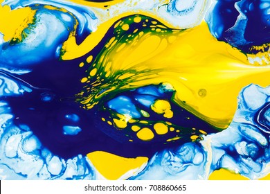 Abstract background of a mixing  blue and yellow color paints