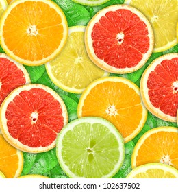 Abstract background with motley citrus-fruit slices and green leaf with dew. Seamless pattern for your design. Close-up. Studio photography.