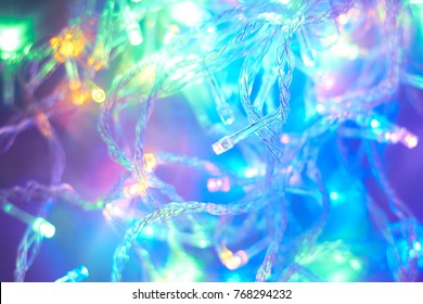 Abstract background of multicolored light bulbs. Christmas garland.