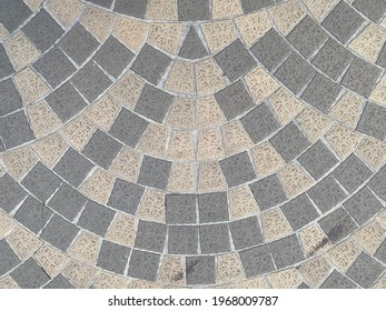 Abstract background ofcobblestone pavement.  Beautiful paving stone Of White, Gray, Yello ornamental patio Floor. Modern rounded decorative area in the park or garden or in backyard garden.