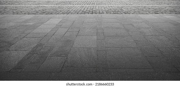 Abstract background of an old cobblestone sidewalk close-up.