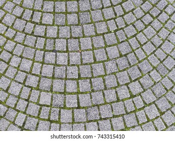 Abstract background of old gray cobblestone pavement close-up, Floor covering at pubblic garden square.