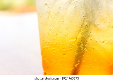 Abstract Background Of Orange Soda Water Beverage Drink With Bubbles In The Glass 