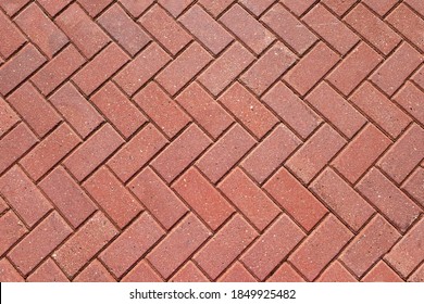 Abstract background from paving red tiles, bricks. Top view of the pavement pattern. Concept for construction, urban environment improvement, finishing works, landscape design.
