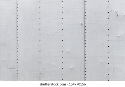 Abstract Background Photo Texture Of Gray Metal Wall With Rivets