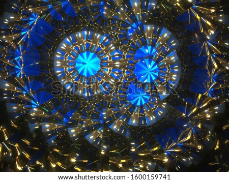Abstract background.  Real shooting done with a kaleidoscope. Main colors: blue, light blue, golden, black and white
