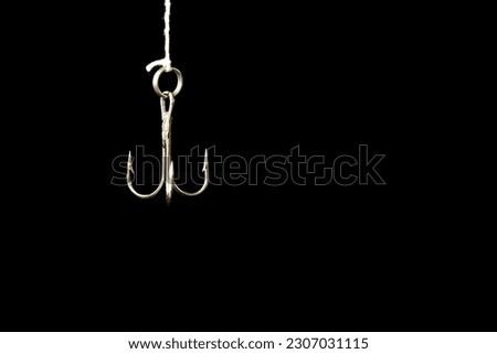 Abstract background for recreation, metal fishing hook isolated on black