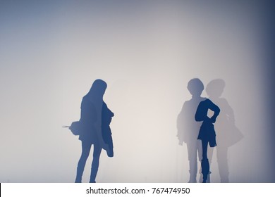 Abstract Background Of Shadows People On A White Wall.