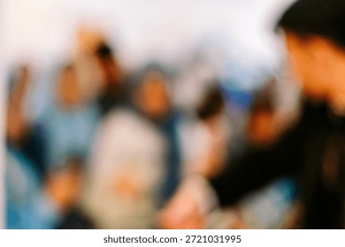 An abstract background with soft focus, featuring indistinct figures and a gentle play of light and shadow, creating a subtle texture.
