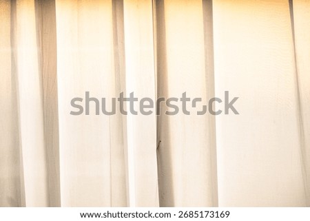 Abstract background of soft light shining through translucent sheer white curtains. Simple, minimalist design.