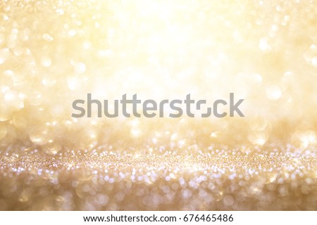 Abstract background in sparkling gold and silver bokeh for a celebratory concept