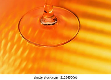 abstract background - stem of the glass and falling red and yellow rays. close up