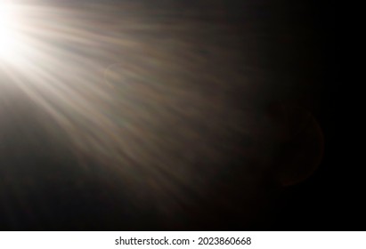 abstract background. Sunbeams from the left on a black background - Shutterstock ID 2023860668
