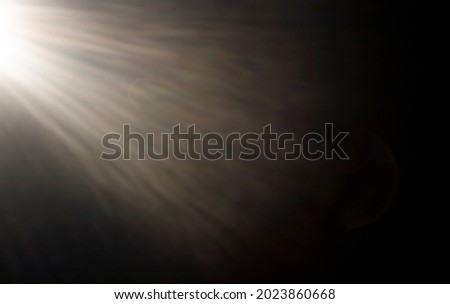 abstract background. Sunbeams from the left on a black background