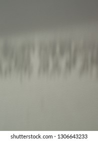 Abstract background of the surface of the window sill with the shadow of snow on the window glass.