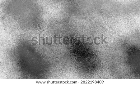 Abstract background texture of black spray paint spots on white wall surface with stipple noise effect