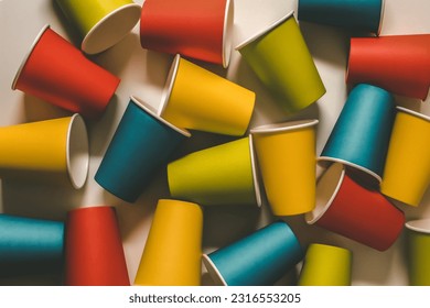 abstract background texture colorful take away paper cups flat lay on white background with dark shadow shade. 
