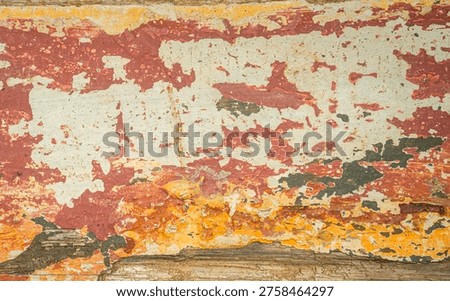 Abstract background texture featuring aged, rustic wood with faded and chipped paint. The warm orange, red, white, and brown tones create a beautiful vintage grunge pattern for graphic design.