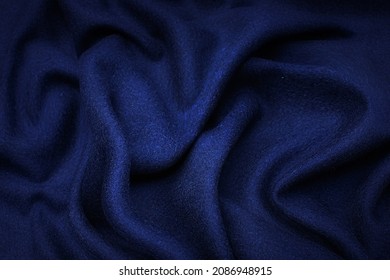 Abstract background texture of natural blue color fabric. Fabric texture of natural cotton or linen, silk or satin, wool or jersey textile material. Luxurious blue canvas background. Arkivfotografi