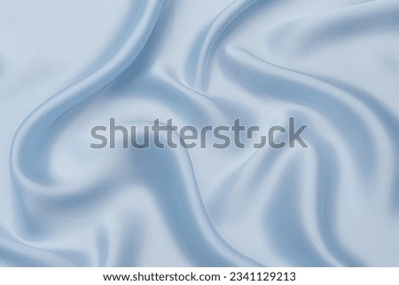 Abstract background texture of natural blue color fabric. Fabric texture of natural cotton or linen, silk or satin, wool or jersey textile material. Luxurious blue canvas background.
