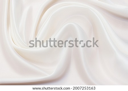 Abstract background texture of natural light color fabric. Fabric texture of natural cotton or linen, silk or satin, wool or jersey textile material. Luxurious white canvas background.