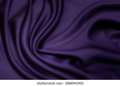 Abstract background texture of natural violet, purple or lilac color fabric. Fabric texture of natural cotton or linen, silk or satin, wool or jersey textile material. Luxurious modern canvas textile.
