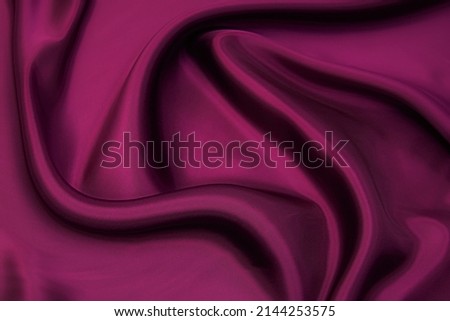 Abstract background texture of natural violet, purple or lilac color fabric. Fabric texture of natural cotton or linen, silk or satin, wool or jersey textile material. Luxurious modern canvas textile.