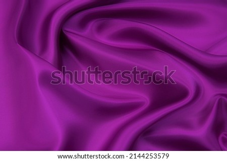 Abstract background texture of natural violet, purple or lilac color fabric. Fabric texture of natural cotton or linen, silk or satin, wool or jersey textile material. Luxurious modern canvas textile.
