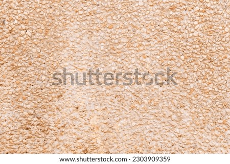 Abstract Background or texture of pebbles small or gravel color yellow, orange attached with beautiful cement concrete. Natural pattern used to make wallpaper website along walls of houses, building.	