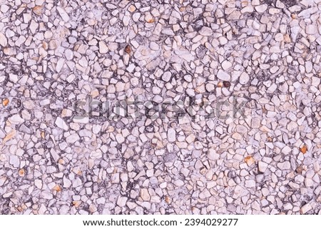 Abstract Background or texture. Pebbles small or gravel color yellow, orange attached with beautiful cement concrete. Natural pattern used to make wallpaper website along walls of houses, building. 