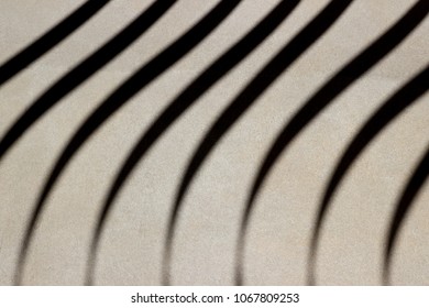 Abstract background texture of shade and shadow parallel curve line pattern on the white floor. Effect from sunlight and railing. Concept of line pattern, The art of shade and shadow.