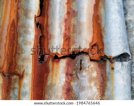 abstract background texture.The surface of the rusted steel.orange and brown color on material. Weathered old zinc fence

