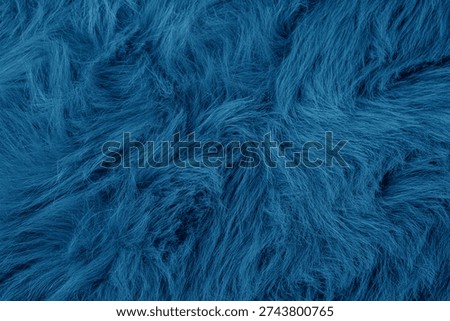 Abstract background of textured deep blue plush soft shaggy faux fur material fabric detail