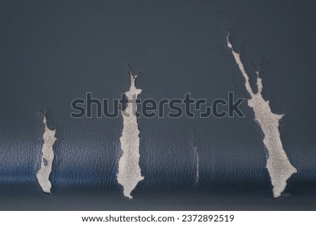 Abstract background of torn old leather sofa. Close up of lack old leather seat for pattern.