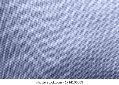 abstract background: unique wavy pattern of overlaying two grids, blurred and tinted to denim color