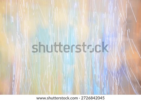 An abstract background with vertical light trails, a long exposure effect and a soft glow in pastel tones.