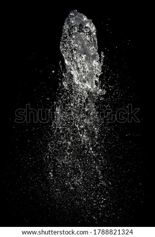 Abstract background with water drops. Jet of water in a fountain on a black background