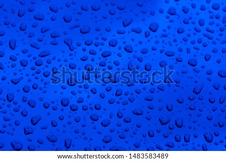Abstract background with water drops on metal surface close up