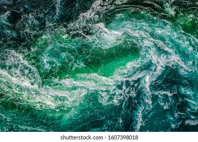 Abstract background. Waves of water of the river and the sea meet each other during high tide and low tide. Whirlpools of the maelstrom of Saltstraumen, Nordland, Norway - Shutterstock ID 1607398018