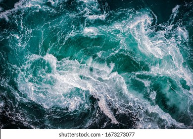 Abstract background. Waves of water of the river and the sea meet each other during high tide and low tide. Whirlpools of the maelstrom of Saltstraumen, Nordland, Norway - Shutterstock ID 1673273077
